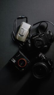 Retro Film Cameras Flat Lay on Dark Minimalist Surface Wallpaper