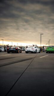 Supercar Meetup Under Dramatic Sunset Sky Mobile Wallpaper