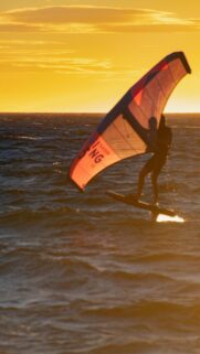 Stunning Golden Hour Wing Foiling Over the Ocean Mobile Wallpaper
