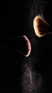 Elegant Makeup Brushes with Sparkling Pink Powder Mobile Wallpaper