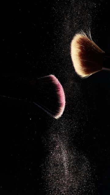 Elegant Makeup Brushes with Sparkling Pink Powder Mobile Wallpaper