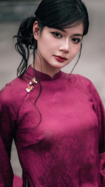 Elegant Asian Woman in Traditional Magenta Ao Dai Mobile Wallpaper