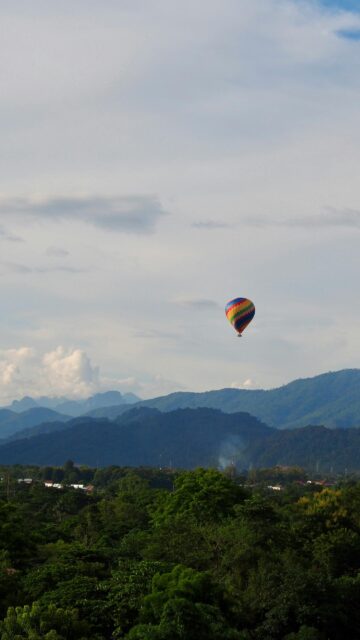 Colorful Hot Air Balloon Over Misty Mountain Landscape Wallpaper