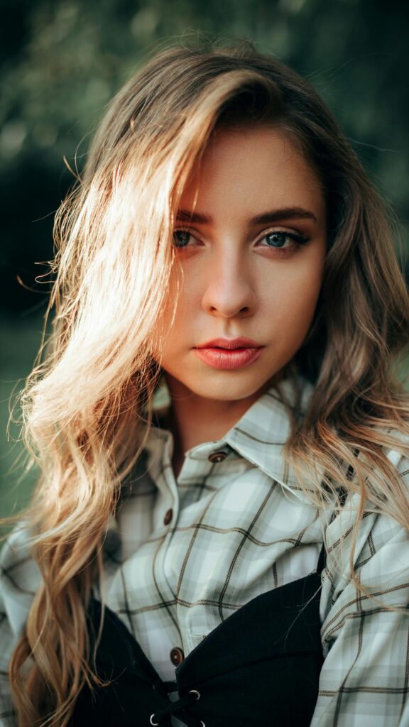 Stunning Portrait of a Young Woman with Soft Golden Hour Lighting Wallpaper