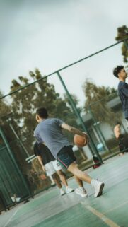 Dynamic Street Basketball Player on Outdoor Court Action Wallpaper