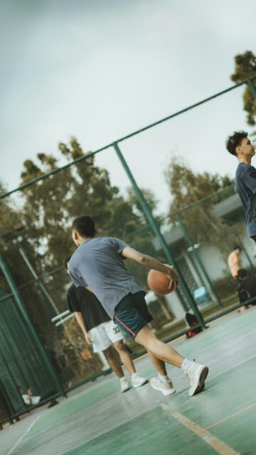 Dynamic Street Basketball Player on Outdoor Court Action Wallpaper
