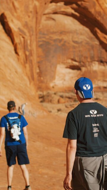BYU Fans Hiking Through Scenic Desert Sandstone Canyon Mobile Wallpaper