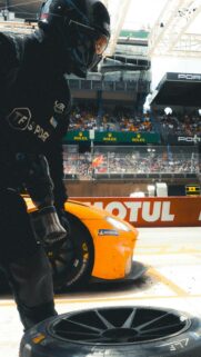 High-Speed Formula Racing Pit Stop Action Mobile Wallpaper