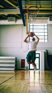 Dynamic Basketball Player Mid-Air Jump Shot Mobile Wallpaper