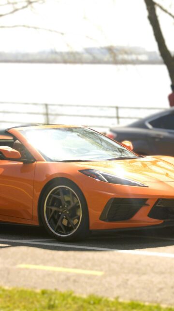 Vibrant Orange Chevrolet Corvette Convertible Sports Car Wallpaper