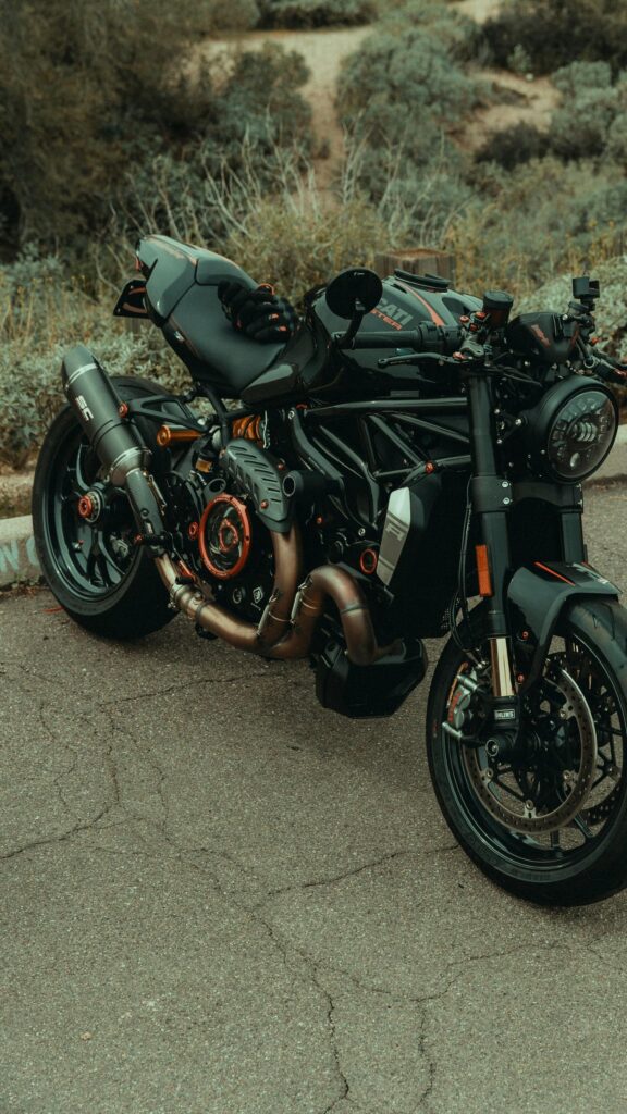 Custom Black Ducati Monster Sport Bike with Orange Accents Wallpaper