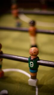 Macro Shot of Vintage Green Foosball Player Number Nine Wallpaper