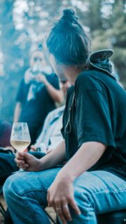 Relaxed Outdoor Social Gathering with Wine Glass Phone Wallpaper
