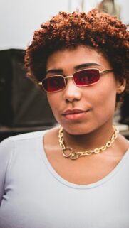Stylish Woman with Red Sunglasses and Gold Chain High Quality Mobile Wallpaper