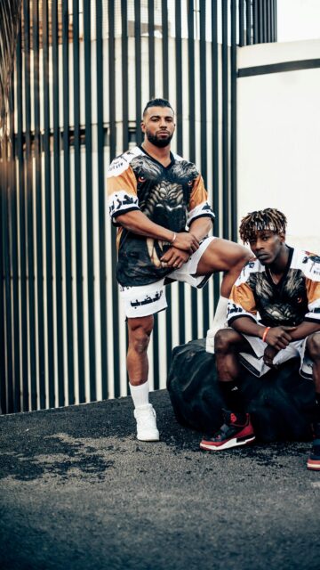 Athletic Duo in Streetwear Urban Gym Fashion Mobile Wallpaper