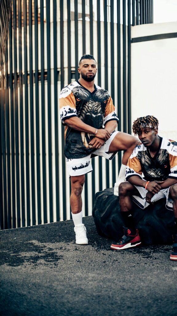 Athletic Duo in Streetwear Urban Gym Fashion Mobile Wallpaper
