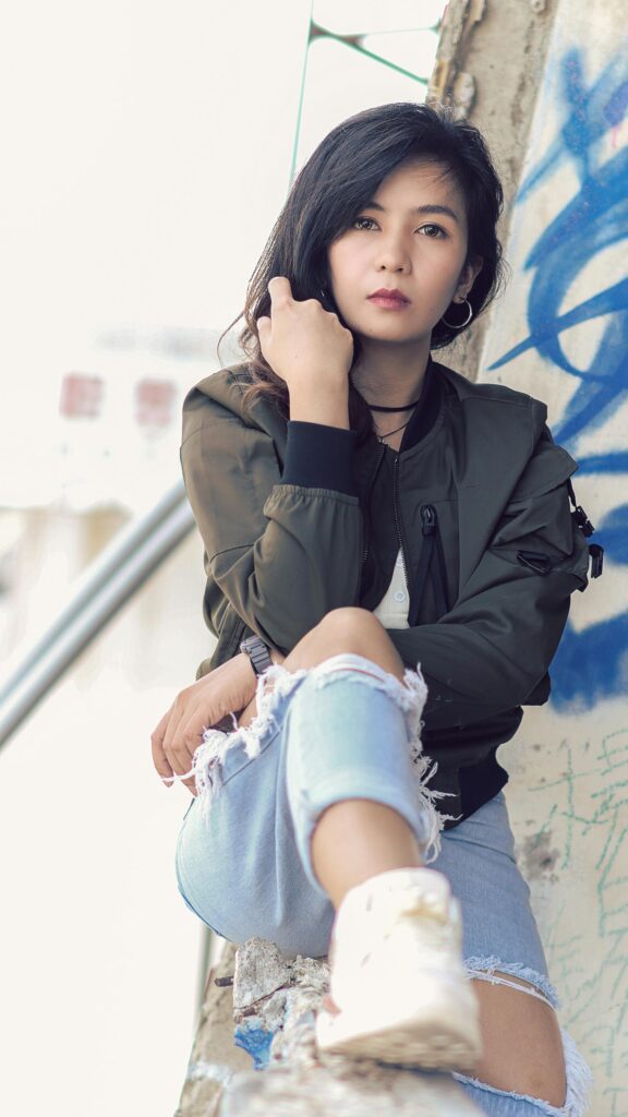 Stylish Asian Woman in Olive Bomber Jacket Urban Portrait Wallpaper