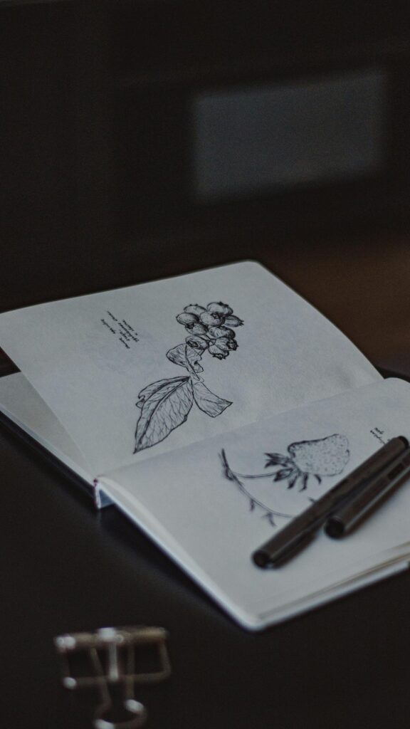 Minimalist Botanical Ink Sketch Art on Open Sketchbook Mobile Wallpaper