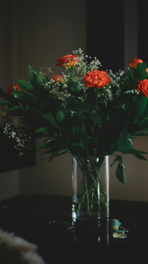 Elegant Orange Rose Bouquet in a Glass Vase Aesthetic Wallpaper