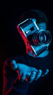Floating Vintage Film Camera with Neon Blue and Red Light Wallpaper