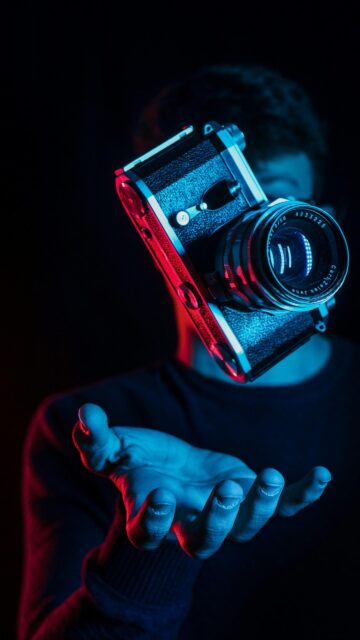 Floating Vintage Film Camera with Neon Blue and Red Light Wallpaper