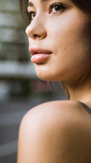 Stunning Close-up Portrait of a Beautiful Young Woman Phone Wallpaper