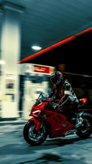 Ducati Panigale V4 Sportbike Racing Through Gas Station Night Wallpaper