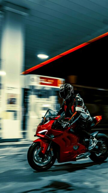 Ducati Panigale V4 Sportbike Racing Through Gas Station Night Wallpaper