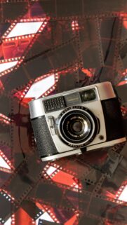 Vintage Balda Baldessa Camera on Retro Film Strip Background Wallpaper