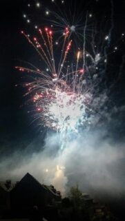 Stunning Night Sky Fireworks Over Village Silhouettes Mobile Wallpaper