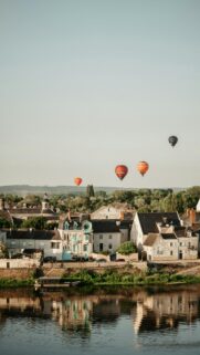 Serene Town and Hot Air Balloons over the River Sunset Mobile Wallpaper
