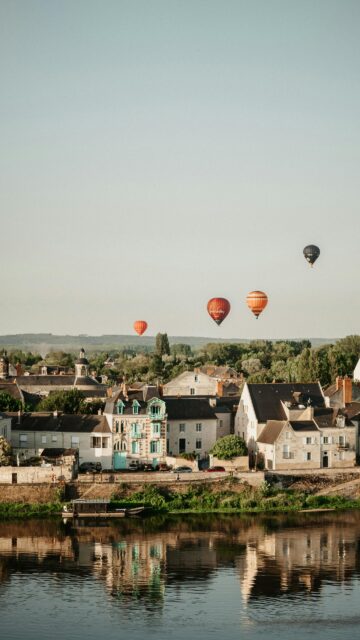 Serene Town and Hot Air Balloons over the River Sunset Mobile Wallpaper