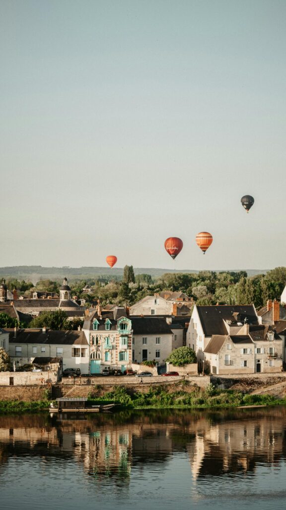 Serene Town and Hot Air Balloons over the River Sunset Mobile Wallpaper
