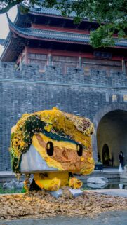 Funko Pop Style Creative Art Statue in Historic China Setting Wallpaper