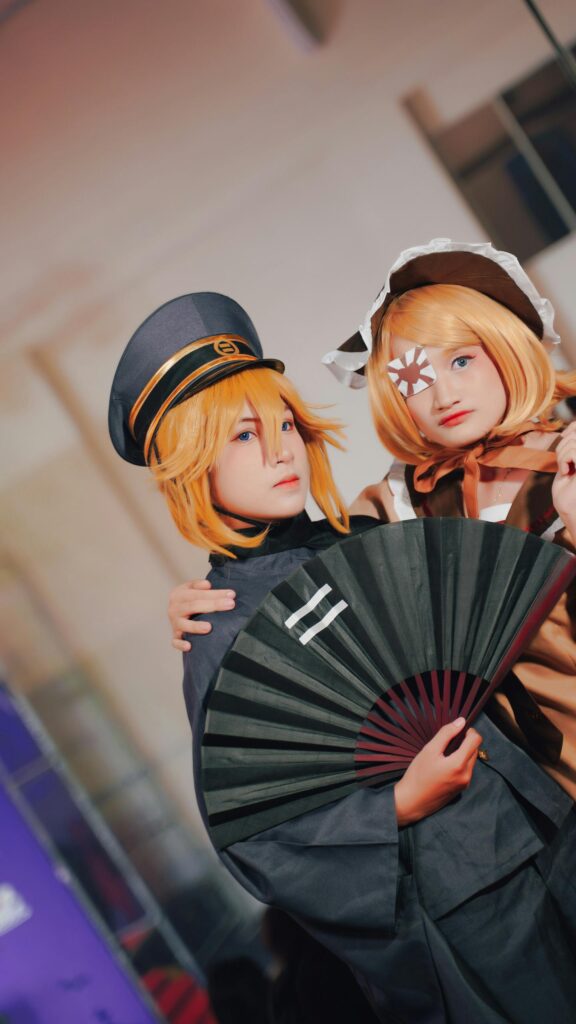 Two Cosplayers Dressed as Anime Characters Portrait Wallpaper