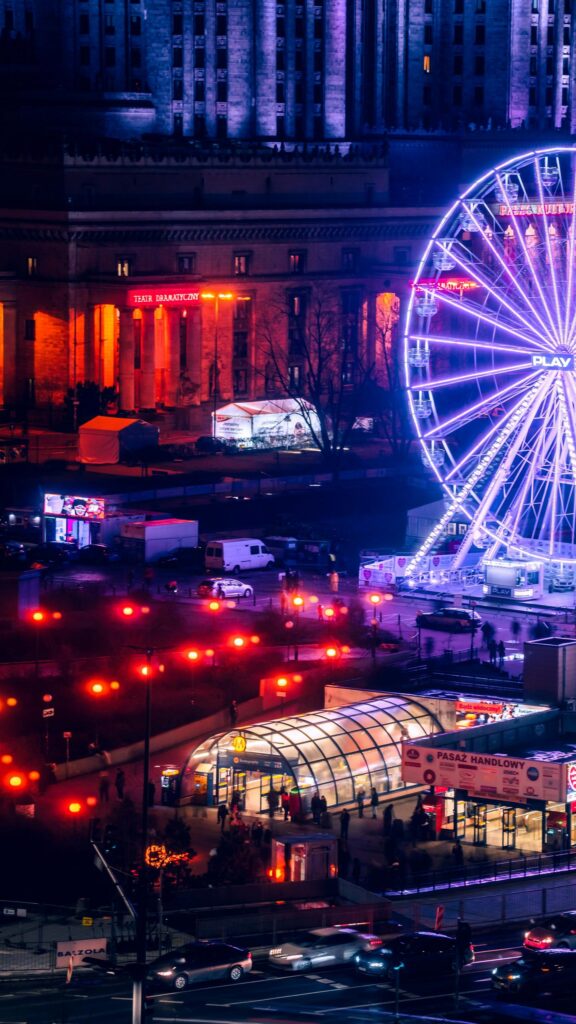 Vibrant Warsaw Night Cityscape with Ferris Wheel Phone Wallpaper