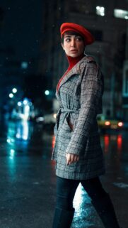 Stylish Woman in Red Beret and Plaid Coat Winter Night Mobile Wallpaper
