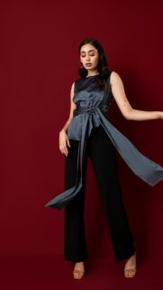 Elegant Woman in Silk Blouse and Black Trousers Mobile Wallpaper