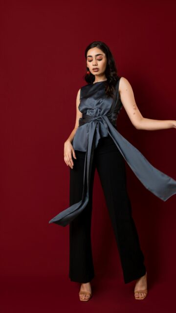Elegant Woman in Silk Blouse and Black Trousers Mobile Wallpaper