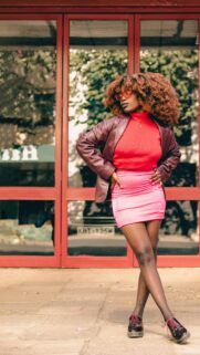 Stylish African Woman in Leather Blazer and Pink Skirt Portrait Wallpaper
