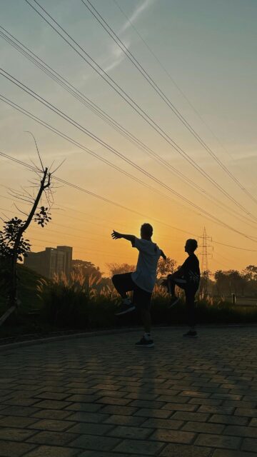 Silhouette People Exercising During Golden Hour Mobile Wallpaper