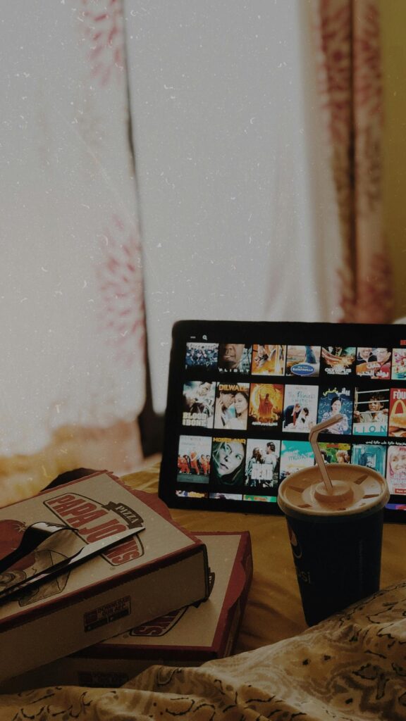Cozy Movie Night Setup with Papa Johns and Netflix Wallpaper