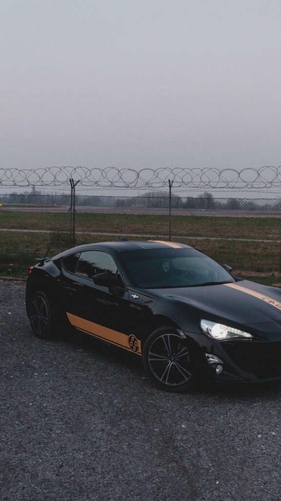 Black Toyota 86 JDM Sports Car with Gold Racing Stripes Wallpaper