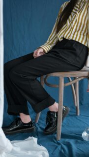 Stylish Woman in Striped Shirt and Black Trousers Aesthetic Wallpaper