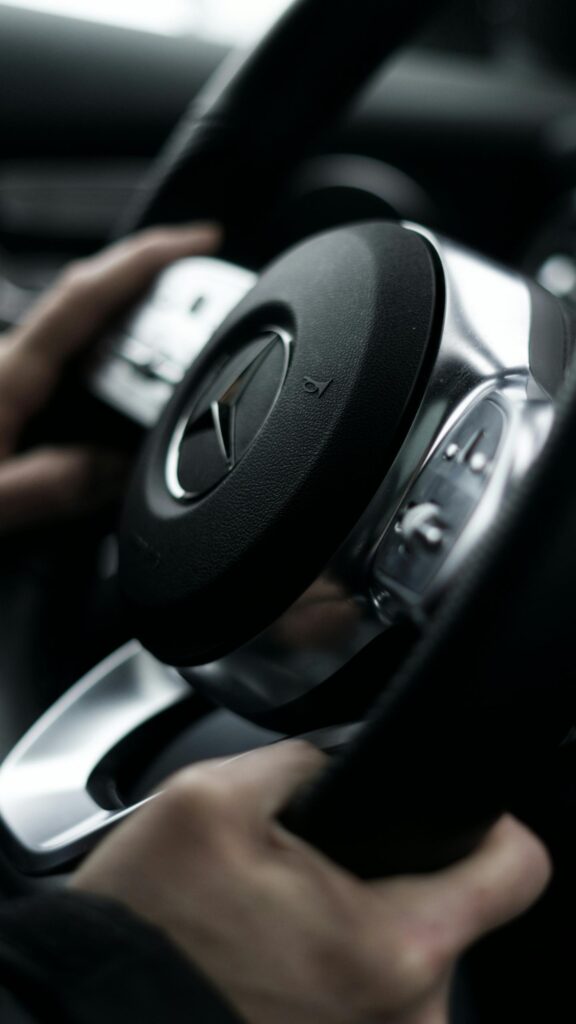 Close-up of a Luxury Mercedes-Benz Steering Wheel Interior Wallpaper