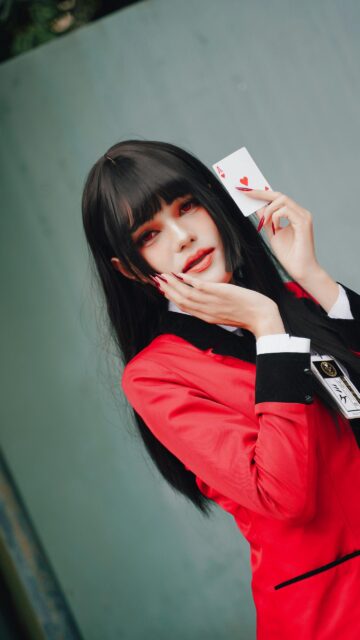 Anime Cosplay Girl with Red Eyes and Playing Card Mobile Wallpaper