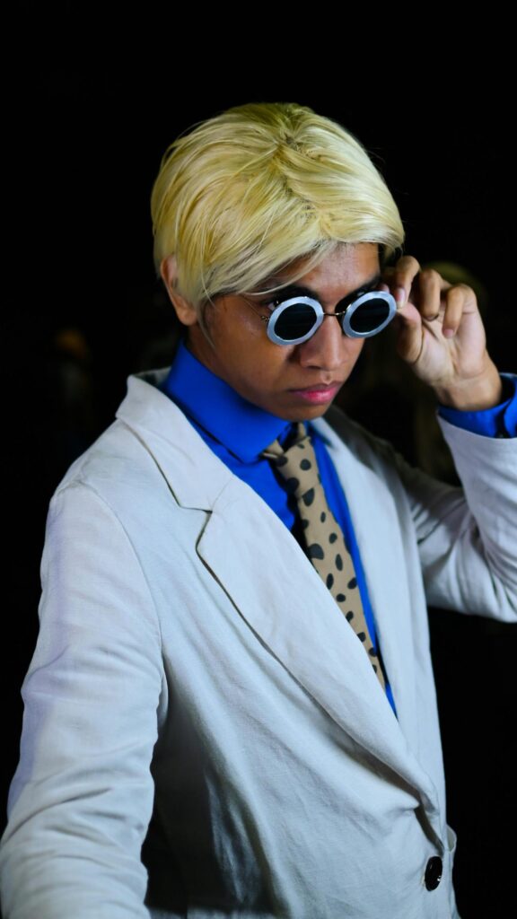 Stylish Man in White Blazer and Round Glasses Cosplay Portrait Wallpaper