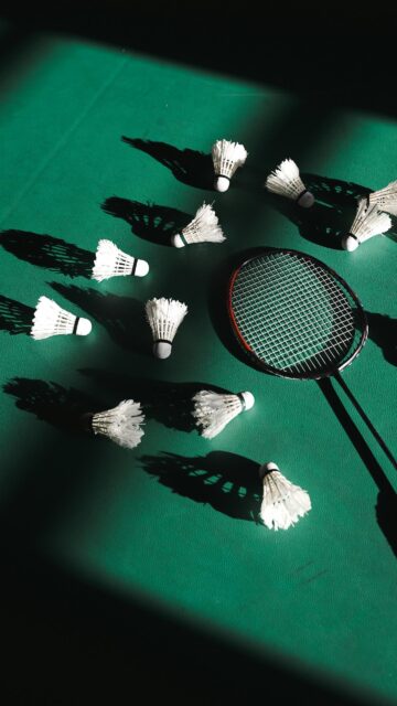 Dynamic Badminton Racket and Shuttlecocks Green Aesthetic Wallpaper