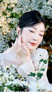 Stunning Portrait of Elegant Woman in Daisy Field Mobile Wallpaper