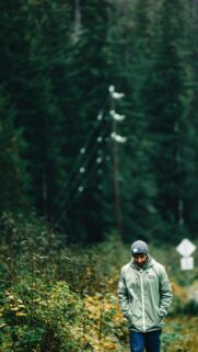 Man Walking in Moody Forest Trail Adventure Mobile Wallpaper